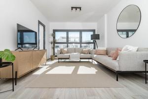 a living room with a couch and a tv at EG5.4A - Luxury Penthouse with Private Sun Terrace in Estepona