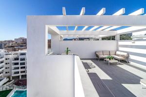 a white apartment balcony with a view of a city at EG5.4A - Luxury Penthouse with Private Sun Terrace in Estepona