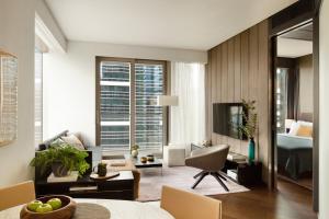 a living room with a room with a bed and a couch at EAST Apartments in Hong Kong
