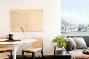 a living room with a table and a couch at EAST Apartments in Hong Kong