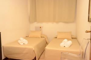 two beds in a room with towels on them at Le Dimore del Conte in Vicenza +53 photos