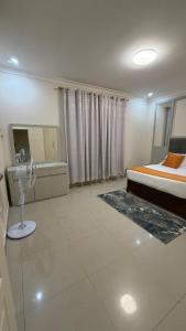 a bedroom with a bed and a sink in it at Artem Apartments - Apartment 3 in Kitwe +15 photos