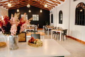 a restaurant with tables and chairs and a bowl of fruit at Uitsig Boutique Hotel in Welkom