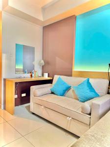 a living room with a couch and a desk at Nico's Studio Condo in Cebu City