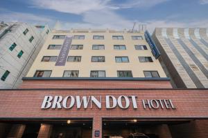 a brown dot hotel sign on top of a building at Brown Dot Hotel Incheon Bupyeong in Incheon