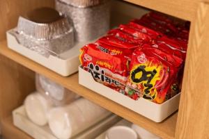 a shelf in a drawer with a box of food at Brown Dot Hotel Incheon Bupyeong in Incheon