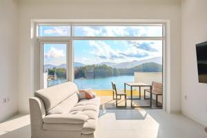 a living room with a couch and a large window at Geoje The Shine Pool Villa in Geoje +43 photos