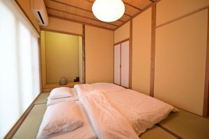 a bed in a room with a large window at ReTune Hokuto in Hokuto +76 photos