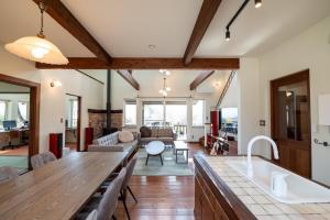 a kitchen and living room with a large table at ReTune Hokuto in Hokuto