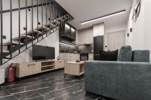 a living room with a couch and a television at Signature Luxury Loft in Volos