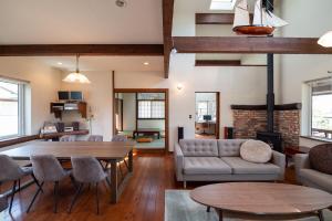 a living room with a couch and a table at ReTune Hokuto in Hokuto
