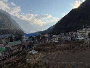 a group of houses in a mountain town with a train at Hotel Sonam Chen Residency Lachung in Lachung