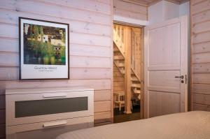 a bedroom with a tv on a wall at Aihki Pine Cottage, Iso-Syöte in Syöte +20 photos