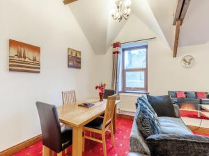 a living room with a table and a couch at The Old Drapery - Uk43568 in Haltwhistle