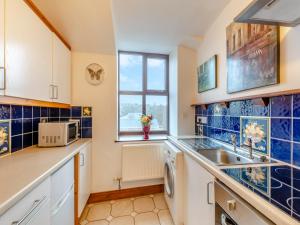 a kitchen with a sink and a window at The Old Drapery - Uk43568 in Haltwhistle
