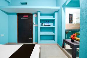 a room with a blue wall with a door and a bench at Hotel O The Shivansh Inn in Chandanpur