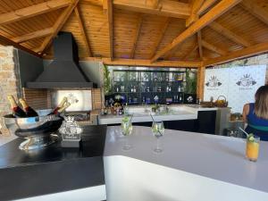 a kitchen with a bar with a sink and a stove at Serenity Residence in Neoi Epivates