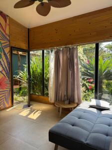 a bedroom with a bed and a large window at Bình An lake view in Buon Ma Thuot