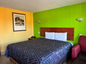 a bedroom with a bed with a green wall at Royal Inn Linden in Linden