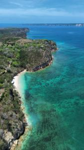 an aerial view of a beach and the ocean at Rasta Homestay Ekas Bay in Pulau Gilkaliantan
