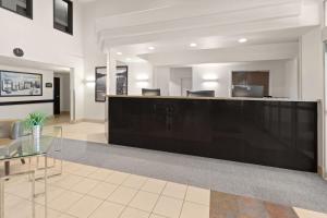a lobby with a reception desk in a building at Super 8 by Wyndham Trois-Rivieres in Trois-Rivières