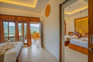a bedroom with two beds and a balcony at Villa Karma Loka in Sidemen +101 photos