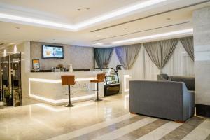 a living room with a bar and a couch at VALY Al-Madinah Hotel in Medina