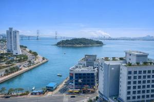 a view of a river with buildings and a bridge at Sky Stay in Incheon +14 photos