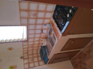 an overhead view of a kitchen with a washing machine at AU JARDIN FLEURI in Sainte-Anne