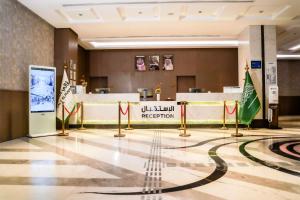 a lobby of a hotel with flags on the floor at VALY Al-Madinah Hotel in Medina