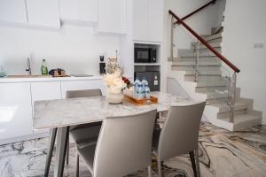 a kitchen with a marble table and chairs at Lumbung Sari Studio in Ngurah Rai International Airport