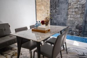 a dining room with a table and chairs at Lumbung Sari Studio in Ngurah Rai International Airport