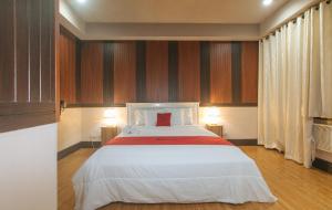 a bedroom with a bed with a red pillow on it at RedDoorz Plus at Canley Residential in Manila +42 photos