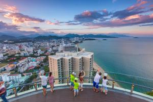 a group of people standing on top of a building overlooking the ocean at Havana Nha Trang Hotel in Nha Trang