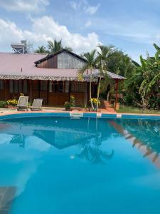 a swimming pool in front of a house at mekong riverside homestay in Vĩnh Long