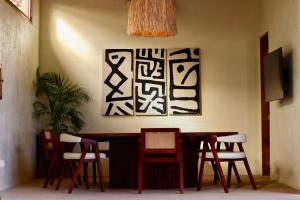 a dining room with a table and four chairs at Baiana Beach Villas in General Luna +19 photos