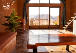 a room with a bench and a large window at Zeina Desert Lodge in Wadi Rum +68 photos