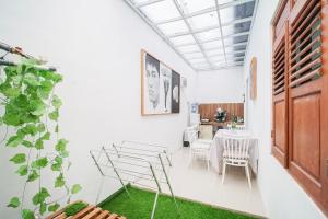 a dining room with a table and chairs at Joglo Prambanan B3 in Bugisan