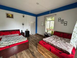 a bedroom with two beds and a window at Padma Riverside Homestay Tabakoshi in Mirik
