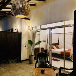 a room with a bed and a desk and a chair at Reefline Villa in Weligama