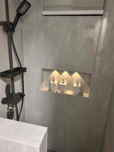 a bathroom with three white urinals on a wall at DG Luxe Suites - Cabanatuan in Bangad +59 photos