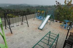 a playground with a slide on a balcony at Ymoon Mountain Resort Wayanad in Koroth