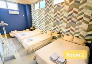 two beds in a room with at MORIHIRO Building in Ichikawa