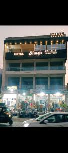 a building with a sign on the side of it at Hotel kingspalace and Dormitory in Vapi