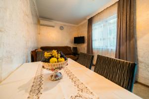 a table with a bowl of fruit on it at Forest in Khulo