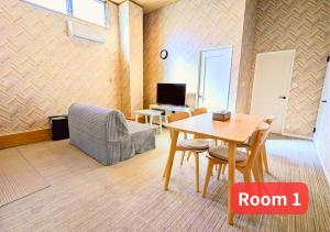 a room with a table and chairs and a room with a desk at MORIHIRO Building in Ichikawa