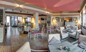 a restaurant with tables and chairs in a room at Hotel Incognito in Jáchymov