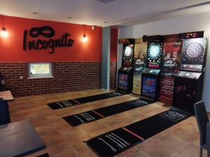 a room with several video game machines on display at Hotel Incognito in Jáchymov