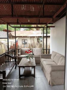 a living room with couches and a coffee table at Little John's Town Inn in Coron