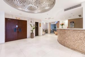 a large lobby with a large ceiling at Achilleos City Hotel in Larnaca